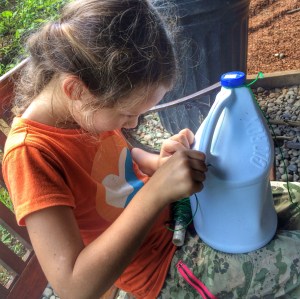 Bella is the middle child in the Wood family. She is the master at helping me with Tippy Tap construction with her super skills in weaving the string into the holes of the plastic bottles. 