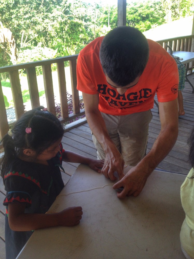 Pat helping a young girl make her bracelet during the craft class that Jess led after my hygiene talk 