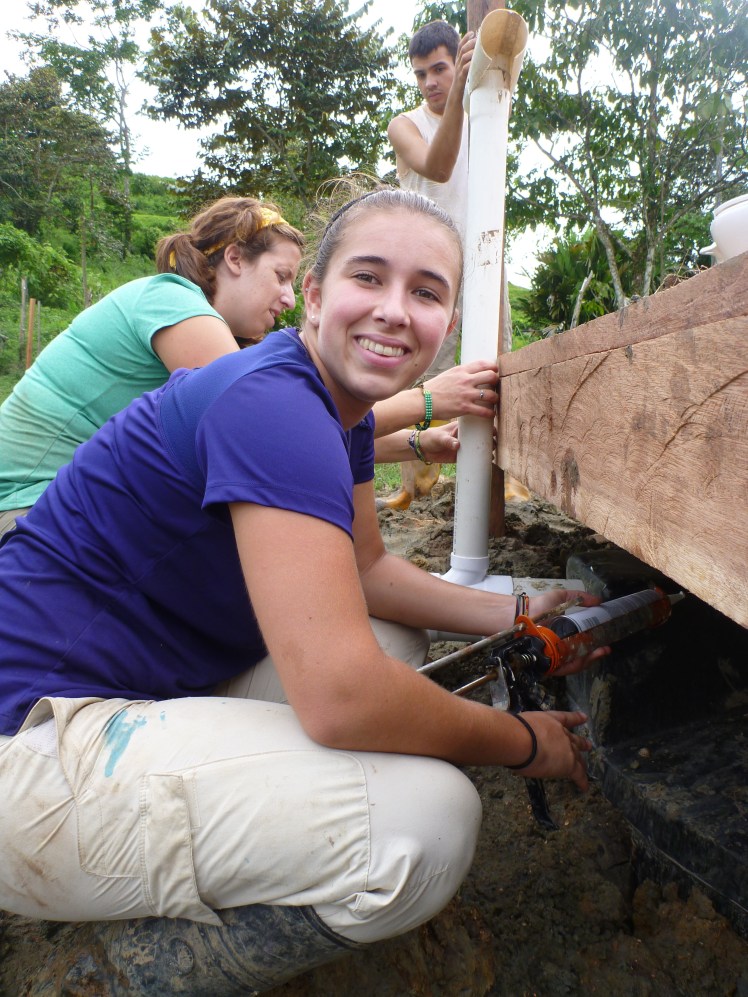 Jess sealing the vent pipe exit