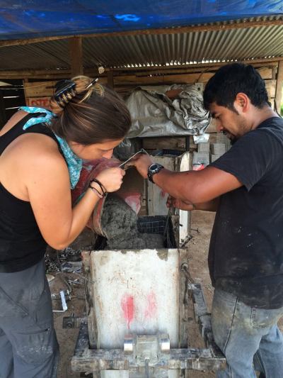 Pouring the cement into the water filter forms 